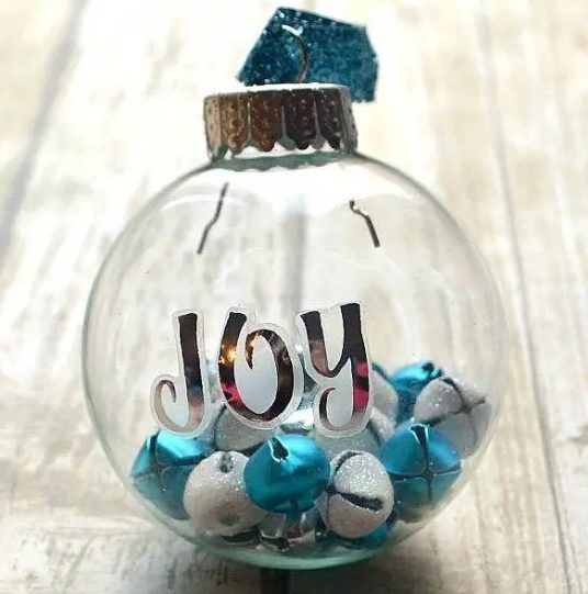 a clear glass Christmas ornament with letters, white glitter and blue bells is a fun and cool way to add color to your Christmas tree