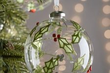 a clear glass ornament decorated with leaves and berries made of rhinestones is a pretty and bright decor idea