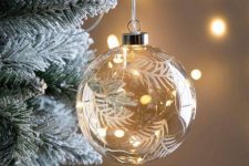 a clear glass ornament painted with lights inside is a very chic and beautiful Christmas decor idea