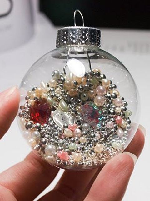 a clear ornament filled with pearls and beads is a glam and fun decor idea for the holidays