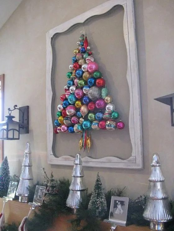 a colorful Christmas tree composed of ornaments attached to the wall and with a frame around for a chic look