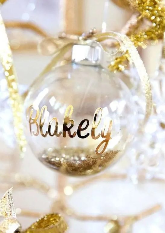 a glitter filled ornament with a name and a bow will be a perfect Christmas gift tag that you can easily make yourself