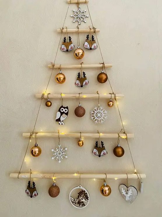 a hanging Christmas tree with branches and yarn, with lights, ornaments and snowflakes is lovely