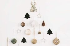 a minimalist wall-mounted Christmas tree of yarn balls, trees, stars and beads is pure chic and elegance
