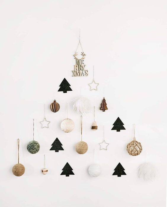 A minimalist wall mounted Christmas tree of yarn balls, trees, stars and beads is pure chic and elegance
