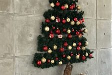 a pretty 3D wall-mounted Christmas tree of evergreens, red and gold ornaments and a heart on top is amazing