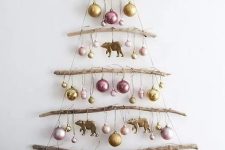 a simple and natural wall Christmas tree of branches and yarn, with pastel ornaments, is a lovely idea