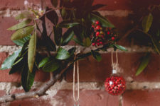DIY transparent glass ornaments filled with moss and berries
