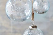 clear Christmas ornaments with painted snowflakes are amazing to make your tree ethereal