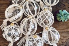 clear glass Christmas ornaments decorated with macrame and tassles are perfect to style your tree boho way