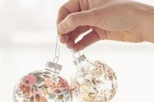 clear glass Christmas ornaments decorated with paints – floral patterns here and there