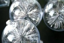 clear glass Christmas ornaments filled with silver tinsel are a simple and quick to realize idea for the holidays