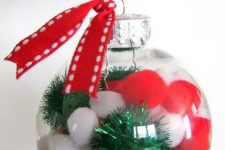 clear glass Christmas ornaments with red and white pompoms and green tinsel pieces, with red ribbon are fun and cool