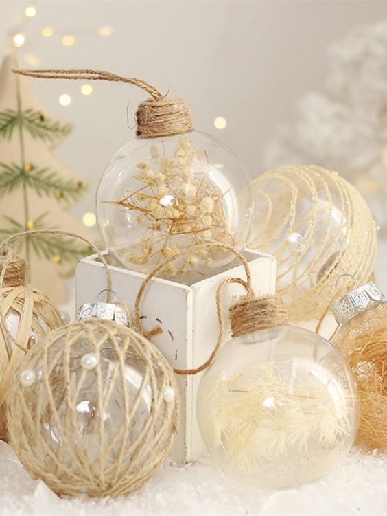 clear glass ornaments filled with feathers and baby's breath and wrapped with twine look very cool