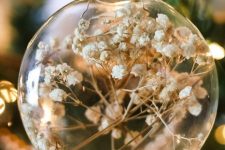 clear glass ornaments with baby’s breath are a beautiful and ethereal Christmas decor idea