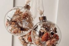 clear glass ornaments with dried blooms, leaves and grasses are amazing for boho Christmas decor