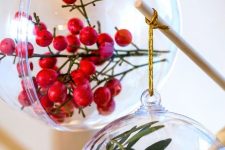 clear ornaments filled with leaves and faux berries look bold and all-natural and will be perfect for Christmas