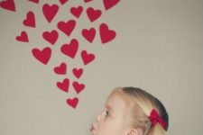 10 photo booth idea with hearts attached to the wall