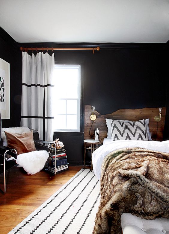 black walls and a white ceiling make room look bigger