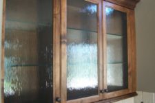 15 stained wood kitchen cabinets with rain glass doors and glass shelves