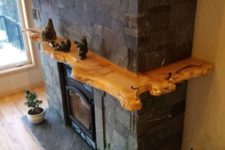 19 a fireplace with a raw edge wooden shelf all around