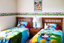 19 colorful shared bedroom with bold bedding and wall decor