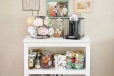 22 cozy coffee station with a lot of colorful mugs and family pictures on the wall