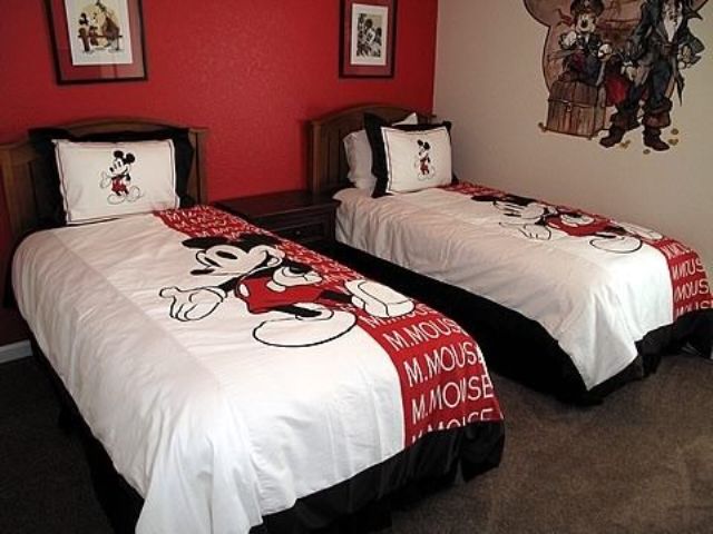 red Mickey Mouse shared bedroom with wall decals and bedding