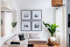 a neutral living room with a simple gallery wall