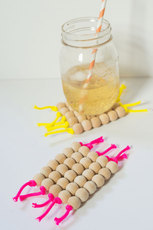 DIY neon cord and wooden bead coasters (via www.shelterness.com)