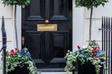 04 bay tree topiaries with flower underplantings give this front door a chic look