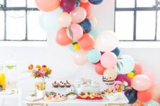 04 colorful balloon garland as a dessert table backdrop