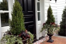 13 black urns with simple variegated ivy, deep heuchera, and ornamental peppers