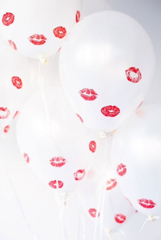 white balloons with red kisses