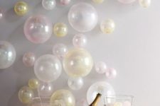 19 pastel balloons attached to the wall as a bacdrop for a drink station