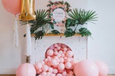 19 pink balloons falling from a faux fireplace