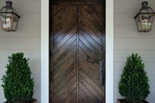 21 stained wood door and wooden planters with boxwood for a rustic feel