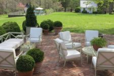 chic herringbone brick patio with contrasting white furniture for a cool look