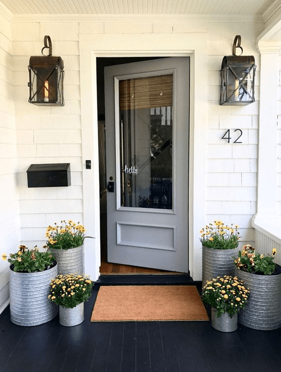 Colorful blooms in galvanized buckets will make your porch feel rustic and spring like
