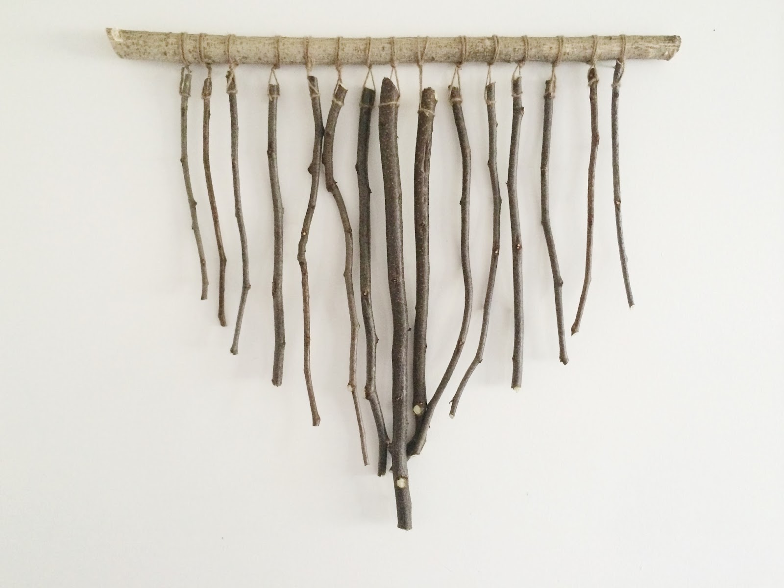 DIY branch wall hanging for rustic spaces (via www.averystreetdesign.com)