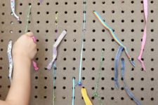 DIY ribbon pull board for kids’ motor skills