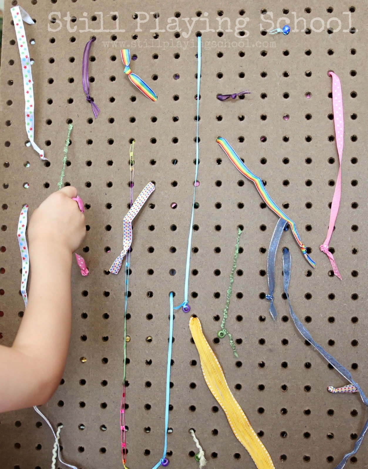 DIY ribbon pull board for kids' motor skills