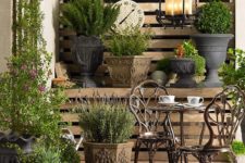 metal bistro set on a brick patio surrounded by plants that enliven the look
