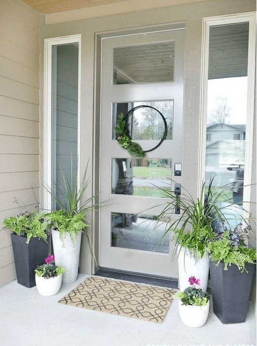 potted greenery, bright blooms and a greenery wreath for a bright spring porch