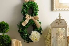 02 a boxwood bunny wreath with burlap ears and a bow and a fluffy tail
