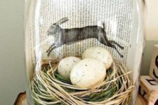 03 a modern terrarium with grass, hay, speckled eggs and a book page