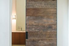 03 a reclaimed barn door looks like a statement in a modern space