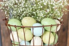 03 a wire basket with pastel eggs and baby’s breath