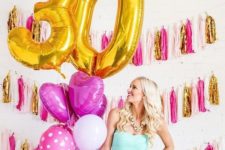 03 gold 30 balloons and bold pink ones for party decor that echo with tassels on the wall