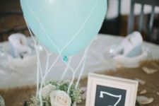 06 a tiny basket with baby’s breath and roses and a blue balloon for a hot air balloon centerpiece